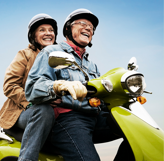 older couple riding a scooter