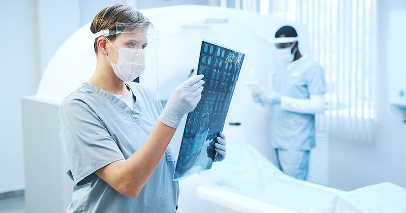 physician looking at x-ray