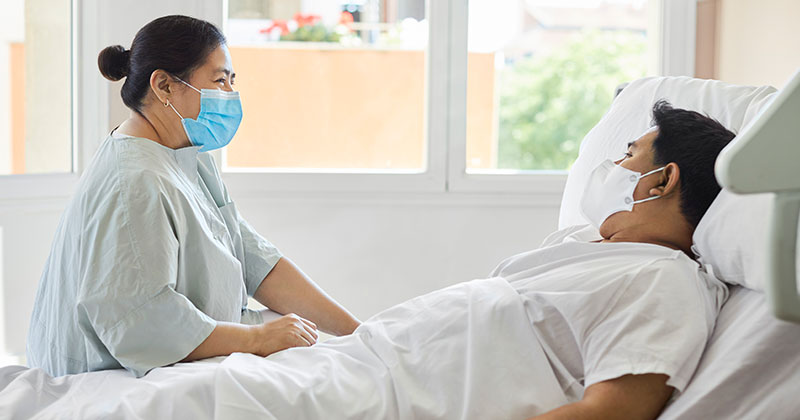 nurse with patient in bed