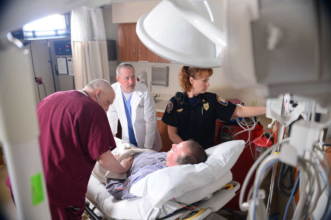 Doctor checking on patient coming into the Emergency Room for chest pain